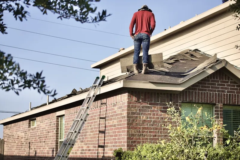 Professional roofer working on a residential roof in River Woods